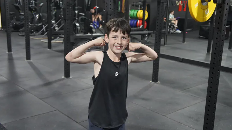 Young athlete flexing at Iron Monk